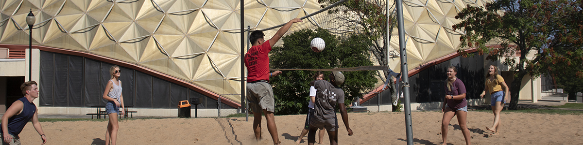 ECU students playing volleyball.