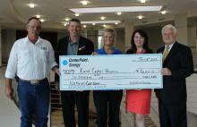 Photo of President Hargrave collecting check from Center Point Energy