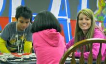 photo of Lacie Lawson with boys and girls club members.