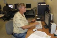 Student working on computers in Upward Bound Office