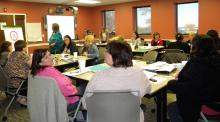 Participants in the Train the Trainer workshop held at the Johnston-Douglas Building by the Chickasaw Nation Child Development Center listen to one of the speakers present data they can use later in their own trainings.