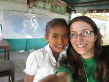 East Central University student Linzi Thompson poses with a young girl in Cambodia during her trip in December.